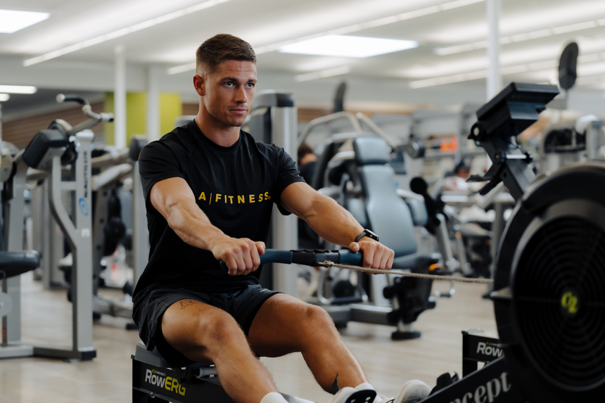 Men’s black S/S Raglan Perforated Knit Tee with yellow text "LA | FITNESS"